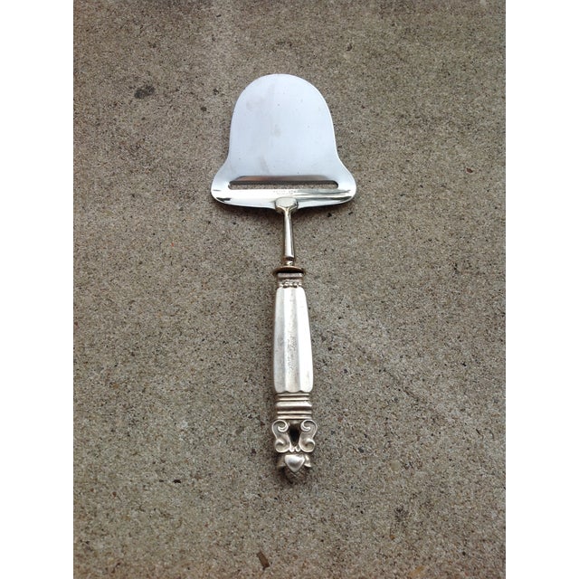 Stately Cheese Plane Slicer from Georg Jensen in the esteemed Acorn Pattern. Sterling Silver handle. Stainless Steel...