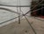 Industrial metal base with crossing metal rods that create stability and attractive flair. Round glass sits atop. 299074NR...