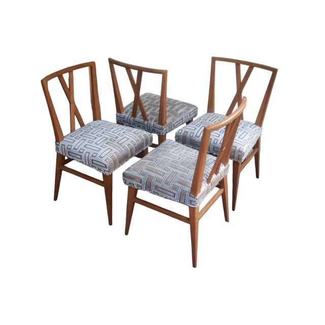 A set of six timeless and elegant X-back mahogany dining chairs designed by Tommi Parzinger for Charak Modern, 1950s....