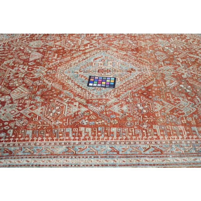 SW Persian, Fars Province, tribal large scatter with a light greyish-blue field supporting a red hexagonal subfield with...