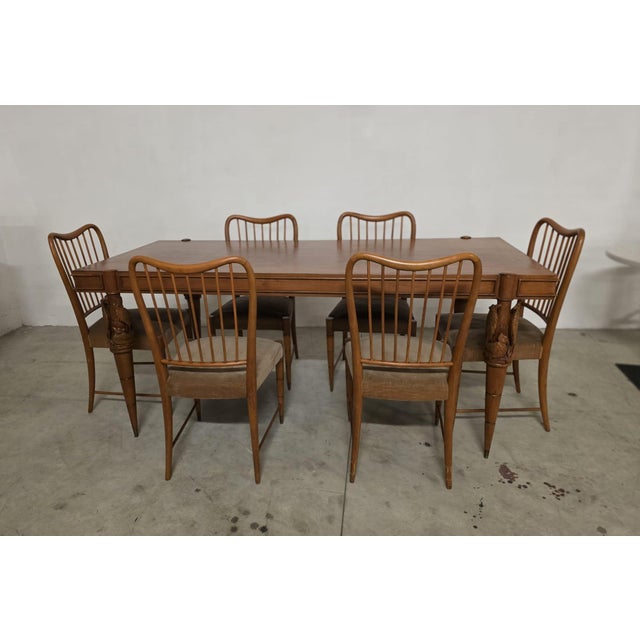 Sculptural table and six chairs by pierluigi colli. elegant oak table with turned legs carved with high reliefs depicting...