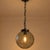 Bring sculptural simplicity to your room with this circa 1970s smoked-glass globe pendant, finished with black metal...