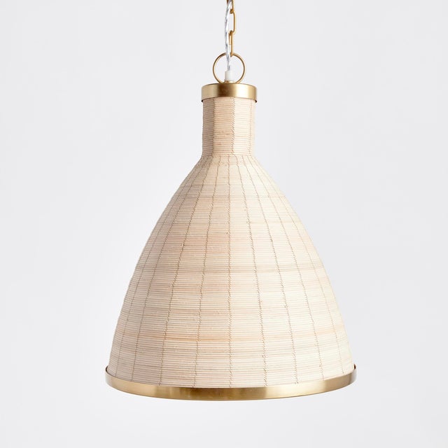 Woven in a natural cane rattan, with subtle variations in color making each one truly unique, this pendant is an instant...