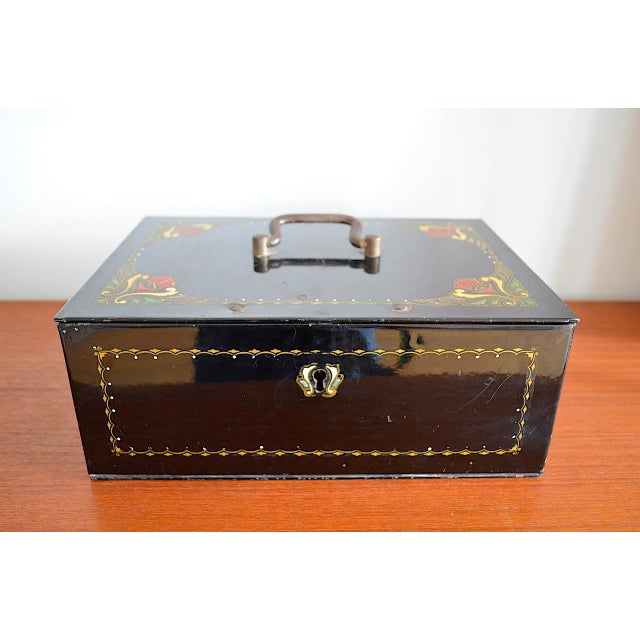A very beautiful jewelry box or cash box from the Art Nouveau period. The metal exterior is painted black with a high-...