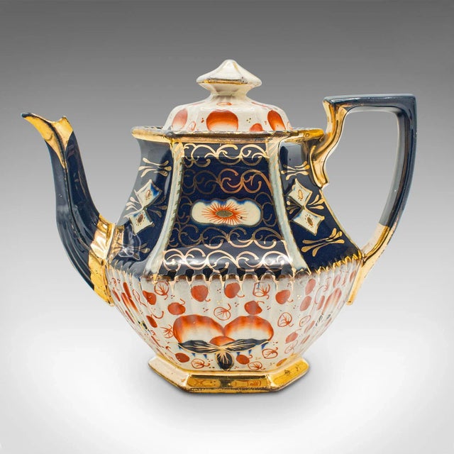 This is an antique Imari pattern teapot. An English, ceramic decorative tea kettle, dating to the late Victorian period,...