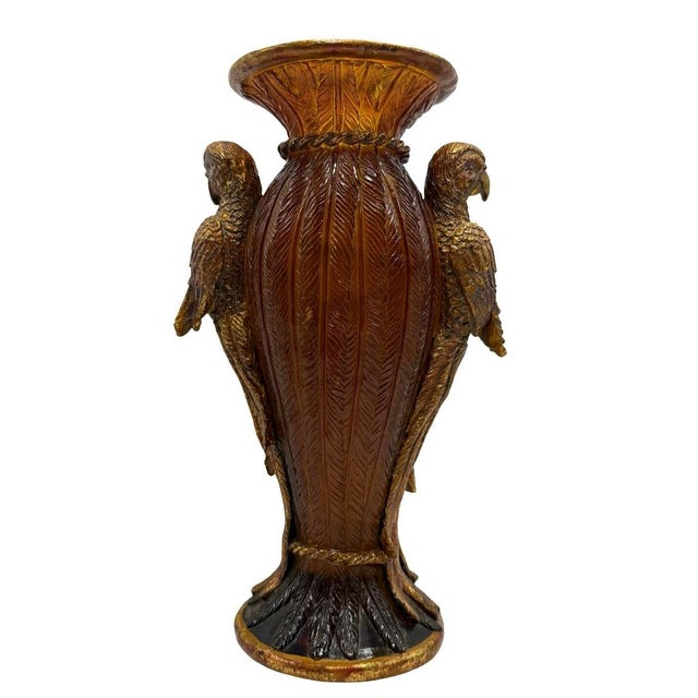 Amber resin vase with gold-accented parrot and feathered texture, a striking decorative element for any interior setting....