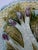 White spears with purple tips on a bed of green leaves with turquoise ground and soft yellow basket weave pattern in the...