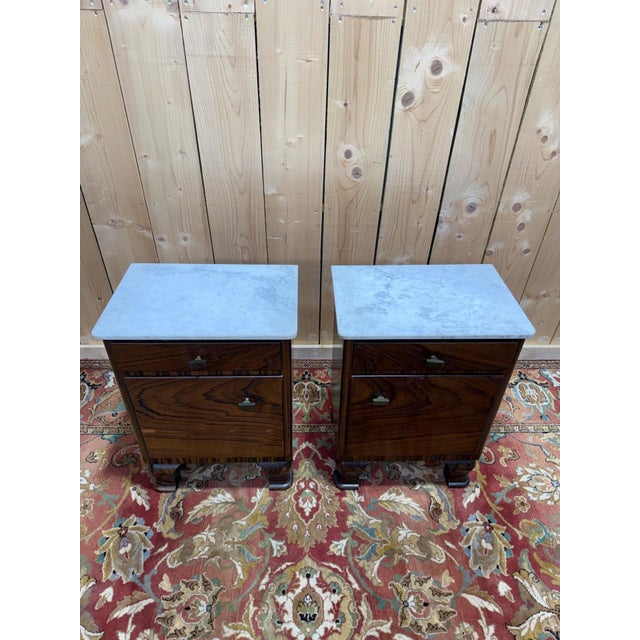 A magnificent pair of art deco bedside tables, likely dating from the 1930s, combining geometric elegance with fine...