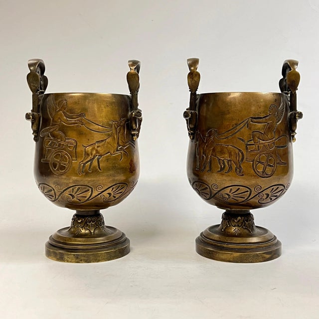 Pair of late 19th century Grand Tour patinated bronze vases with charming Greek motifs including Artemis in her chariot...