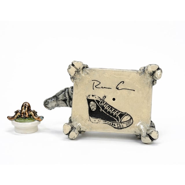 Rhino with Lidded Container Plinth combines playful storytelling with exceptional ceramic craftsmanship, transforming a...