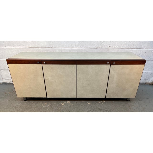 Stylish Mid-Century Modern style office credenza featuring a warm wood-grain finish, clean lines, and generous storage....