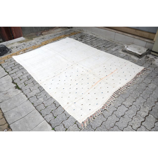 This is a vintage Turkish Oushak rug from the 1960s. The piece was hand-knotted.