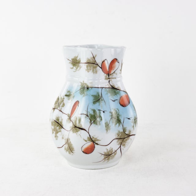 Embrace the beauty of autumn with this exquisite hand-painted porcelain pitcher. Decorated with vibrant orange petals and...