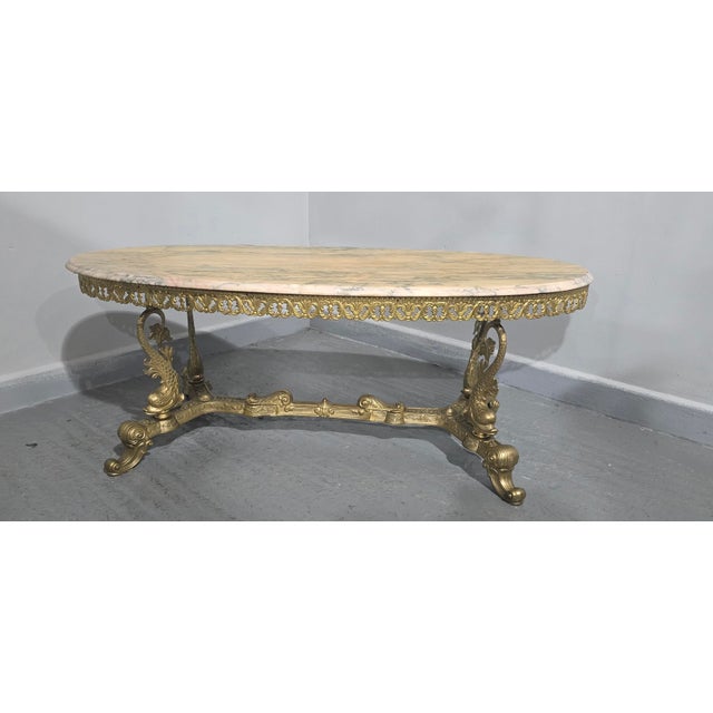 Very nice quality gilt brass oval coffee table with dolphin legs, and super verigated marble top, in excellent overall...