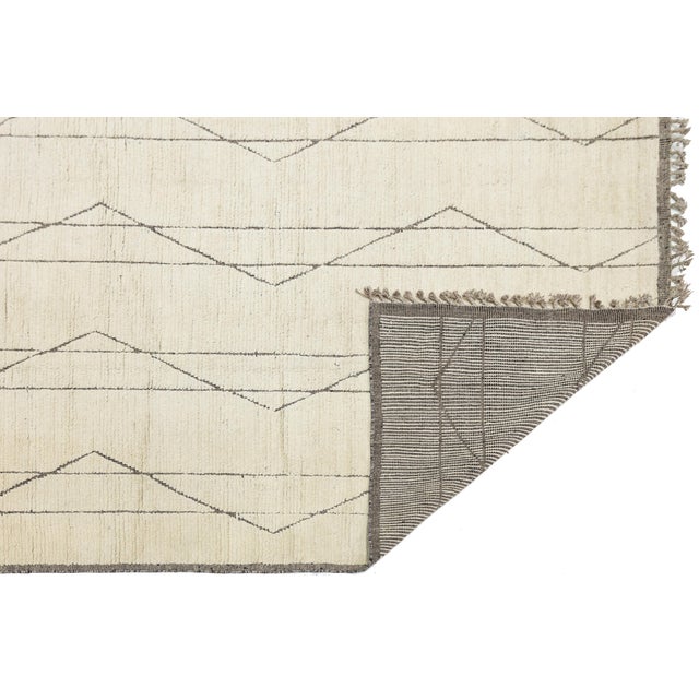 This stunning handcrafted wool rug seamlessly blends traditional Moroccan soul with a crisp, contemporary aesthetic....