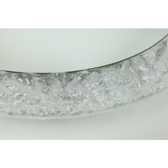 Very nice decorative wall mirror from the 1960s/70s. with anufacturer's label Erco. Oval shape. Acrylic frame with an ice...