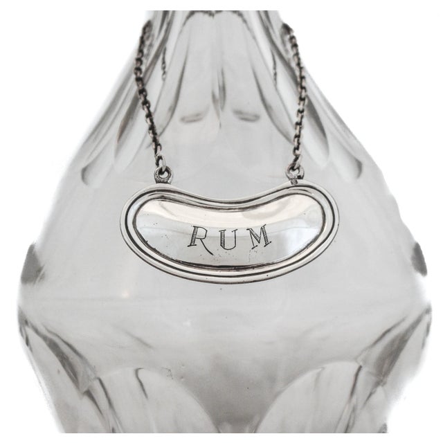 This liquor label is crafted of sterling silver, with the word "Rum" engraved on the front. The perfect tag to put on your...