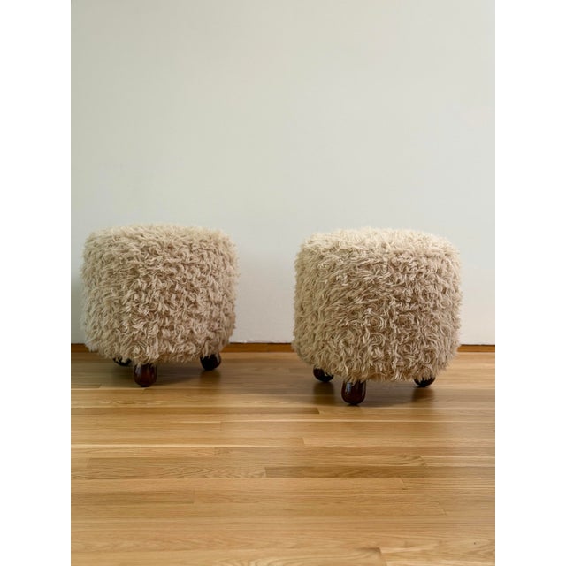 We are very pleased to offer this wonderful pair of vintage ottomans in the style of Jean Royère, featuring beautifully...