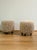 We are very pleased to offer this wonderful pair of vintage ottomans in the style of Jean Royère, featuring beautifully...