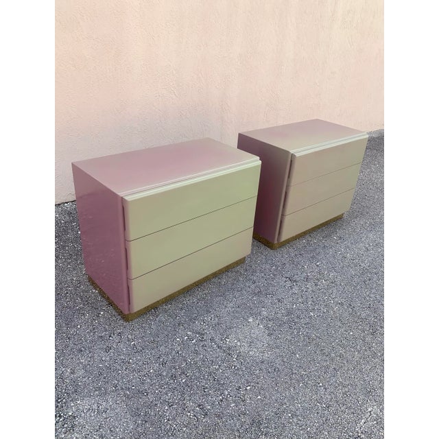 A beautiful and unique pair of nightstands designed by Milo Baughman for Thayer Coggin. Lacquer finished wood atop a brass...