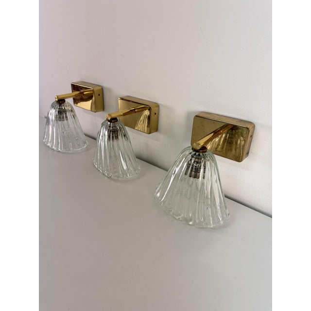 Set of three brass and Murano glass wall lamps in the style of Barovier & Toso, 1950s. Intact glass, E27 bulbs. Good...