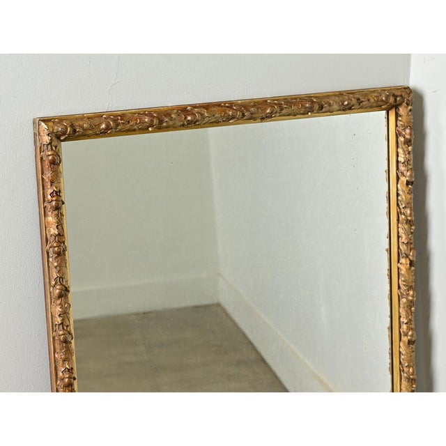 Dimensions: 35” H x 26 ⅛ ” W x 2” D A charming French antique mirror in gold gilt with intricately carved acorns and oak...