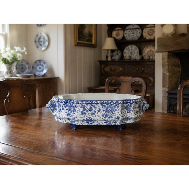 A rare antique French faience blue and white hand painted floral ironstone footed jardiniere or cachepot with lion head...