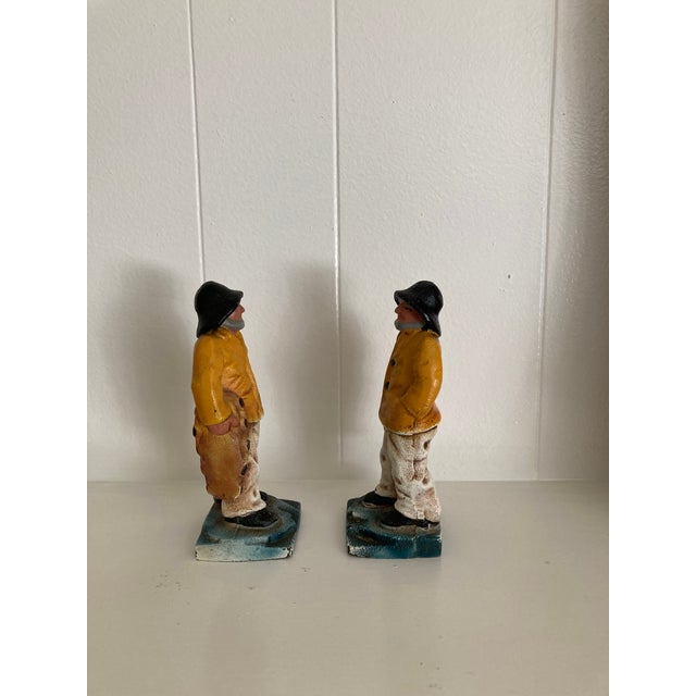Nautical folk Art produced around the 1920s to 1930s, the doorstops/bookends depict a New England fisherman. He is wearing...