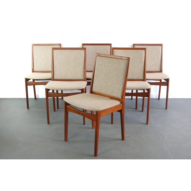The chairs in this set are an exquisite minimal design, constructed in teak and it's original period oatmeal fabric.