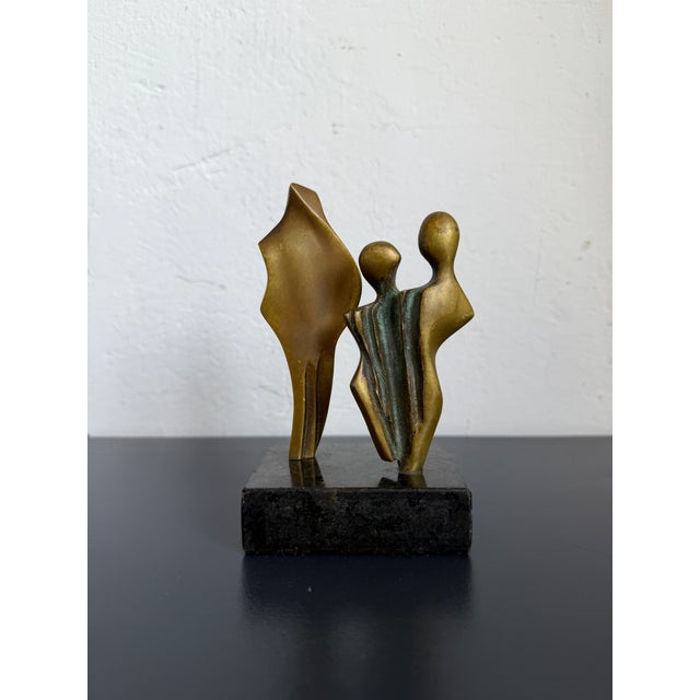 Abstract modern bronze sculpture of three people on black granite base, Brazil 1980s. Artist unknown.