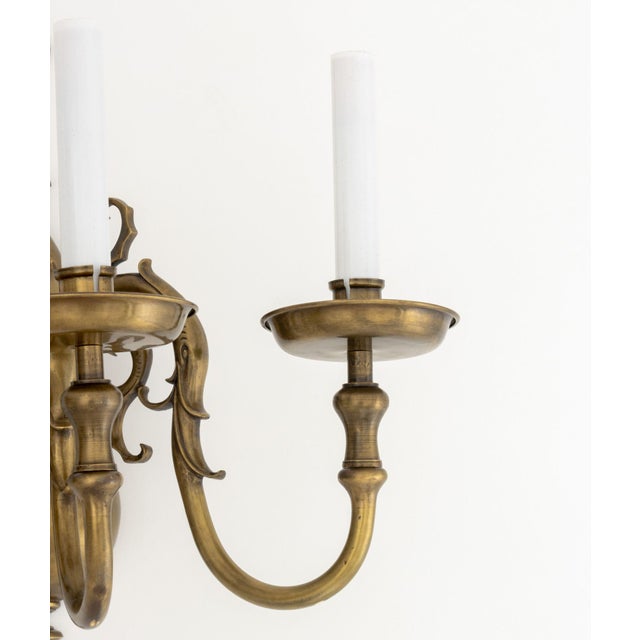 Pair of Dutch Style Bronze Three-Branch Wall Sconces, with orb form backing plate and scroll motif. 15.25" H x 15.5" W x...