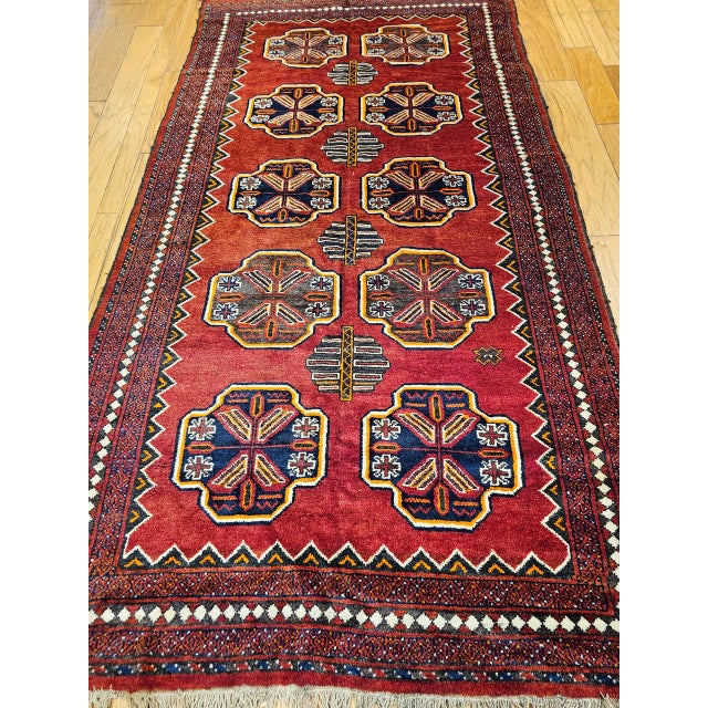 This vintage Afghan Tekke Bokhara rug, woven in the second quarter of the 20th century, embodies the rich tribal artistry...