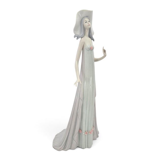 A Lladro The Debutante porcelain figurine, model #1431, from the Elegant Ladies collection. Produced in Spain from 1982...