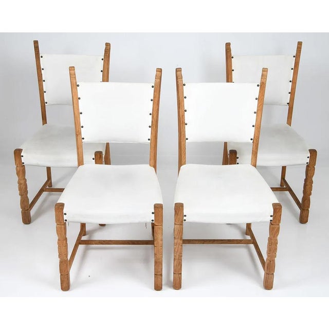 A simple, yet elegant, set of 4 Danish modern dining chairs. The chairs are of solid carved / figured oak and are...