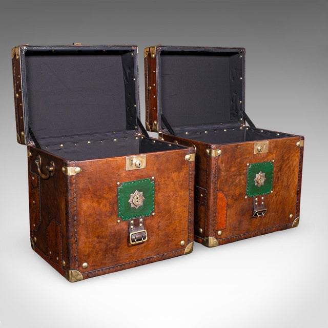 This is a pair of late vintage officer's campaign trunks. An English, leather and brass bedside nightstand, or occasional...