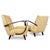 A refined pair of armchairs produced by Interiér Praha, representing classic Czechoslovak design of the 1950s. The...