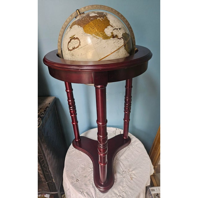 Vintage globe on wood stand. The Globe itself is executed in rich earth tones.