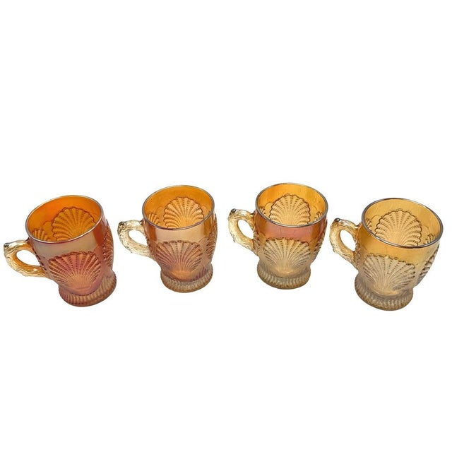 These Dugan-Diamond carnival marigold glass mugs showcase various shades of marigold iridescent finish with a beaded shell...
