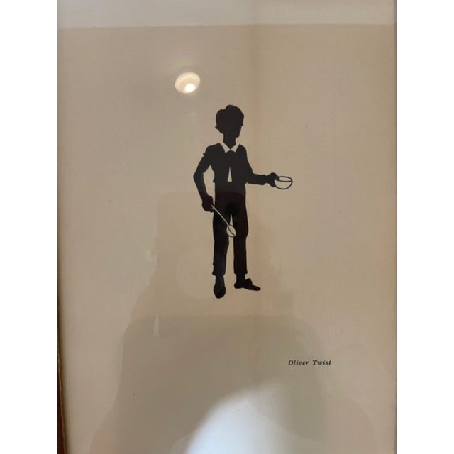 Charles Dicken's Characters, Oliver Twist and Bill Sikes Antique Silhouettes each framed in the original natural wood...