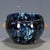 This is a striking vintage porcelain teacup, featuring a dramatic flambé glaze and applied beast-head handles. The cup is...
