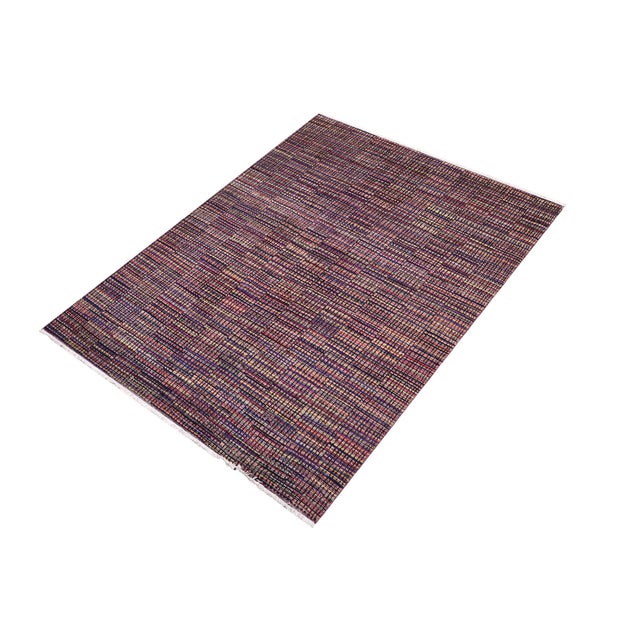 Elevate your interior with this hand-knotted high-low wool area rug, designed to bring depth and dimension to any room....