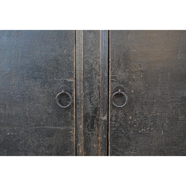 Antique Chinese Painted Rice Cabinet, with two wide doors, in its old, worn, crackled black lacquer finish. Late Qing...