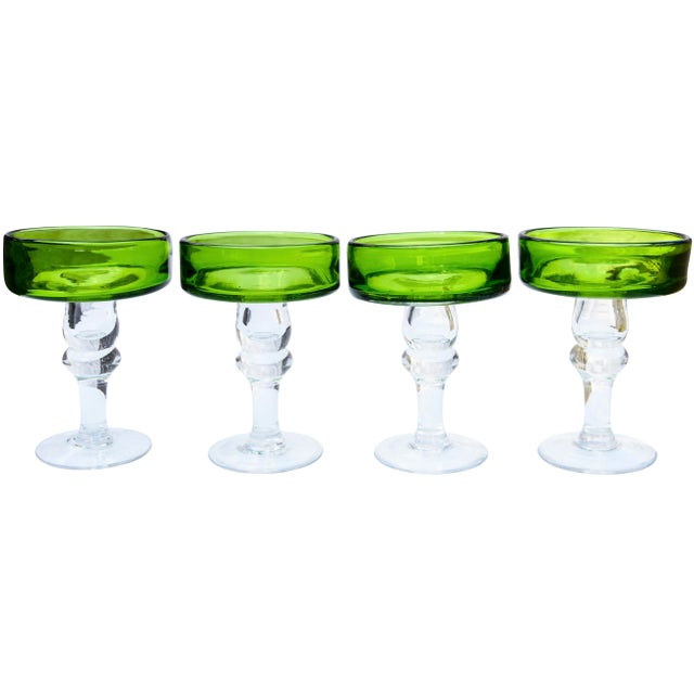 Gorgeous and heavy set of four midcentury green cocktail glasses with ornate bases, stems and intricate details. The...