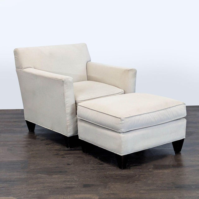 This Crate & Barrel lounge chair with matching ottoman is perfect for relaxing in style. It features a soft cream fabric...