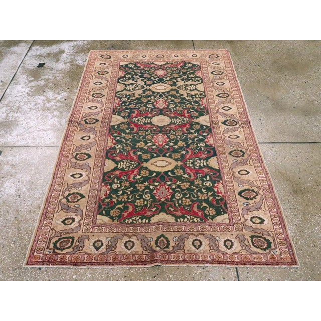 This Mid-20th century Turkish Sivas rug, measuring 4' 0" x 5' 11", is a captivating example of Anatolian weaving with a...