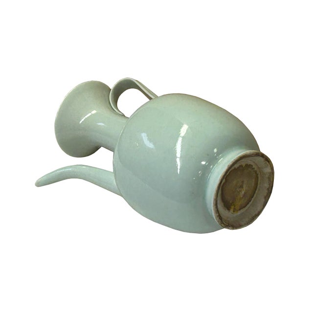This elegant Chinese Qingbai glazed porcelain ewer showcases the delicate "blue-white" aesthetic that flourished during...