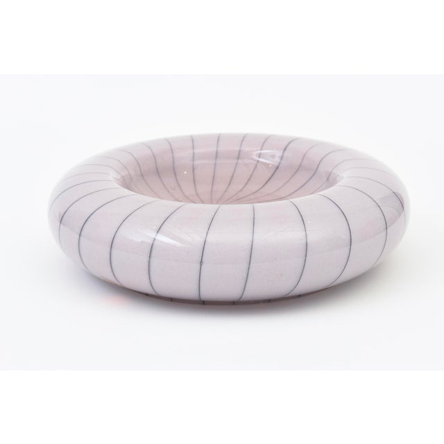 This vintage gorgeous large mid century modern Murano glass bowl is a purple lavender with black stripes. It is made by...