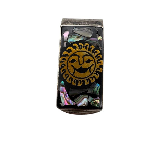 A vintage Mexican sterling silver and abalone sunburst design money clip by Laton, ca. 1970’s. The front has a black...