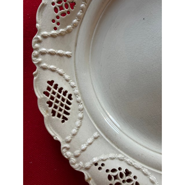Antique 18th century English George III creamware charger plate with shaped rim and reticulated border. Measures 10 1/2"...
