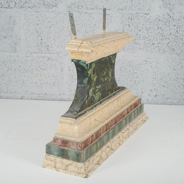 This antique pedestal, made of finely carved and lacquered wood, is a refined antique piece ideal for enhancing historic...